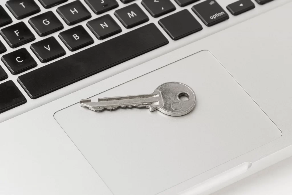 A Key portraying password placed on top of MacBook Tra